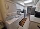 A well-equipped kitchen with stainless appliances, washer/dryer, and tiled backsplash at 605 Brandy Wine Dr # 605, Largo, FL 33771