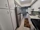Well-lit kitchen featuring stainless steel appliances, tile floors, and ample cabinet space at 605 Brandy Wine Dr # 605, Largo, FL 33771