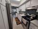 Bright kitchen with stainless steel appliances, mosaic backsplash, and tile flooring at 605 Brandy Wine Dr # 605, Largo, FL 33771