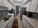A functional kitchen layout with stainless steel appliances and ample counter space at 605 Brandy Wine Dr # 605, Largo, FL 33771