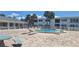 Community pool with lounge chairs, tables, and seating area at 605 Brandy Wine Dr # 605, Largo, FL 33771