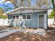 Exterior view of the backyard featuring a paved patio, A/C unit, and bamboo plants at 623 15Th Nw Ave, Largo, FL 33770