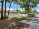 Spacious fenced backyard featuring mature trees, patio area and shed with screen windows at 623 15Th Nw Ave, Largo, FL 33770