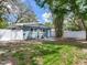 Backyard with a fenced-in yard and grass area, bamboo, and rear exterior of the property at 623 15Th Nw Ave, Largo, FL 33770