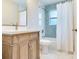 Bathroom with wooden vanity, marble floors, and tub with a herringbone tile surround at 623 15Th Nw Ave, Largo, FL 33770