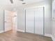 Bright bedroom features light wood floors, an open closet, and a ceiling fan at 623 15Th Nw Ave, Largo, FL 33770