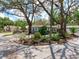 Exterior street view shows mature shade trees, tropical landscape, and corner lot location at 623 15Th Nw Ave, Largo, FL 33770
