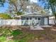 Back exterior of home features a white door, patio, and a fully fenced yard providing privacy at 623 15Th Nw Ave, Largo, FL 33770