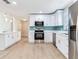 Bright kitchen boasts stainless appliances, modern backsplash, and beautiful hardwood floors at 623 15Th Nw Ave, Largo, FL 33770