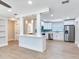 Open-concept living area with a breakfast bar overlooking a modern kitchen, perfect for entertaining and everyday living at 623 15Th Nw Ave, Largo, FL 33770