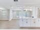 Open-concept living space with light wood floors and a kitchen view, creating a modern and inviting atmosphere at 623 15Th Nw Ave, Largo, FL 33770