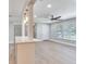 Bright living room featuring a ceiling fan, light wood flooring, and ample natural light through large windows at 623 15Th Nw Ave, Largo, FL 33770