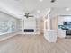 Modern living room boasts built-in shelves, fireplace, and an open design with a view into the adjacent kitchen at 623 15Th Nw Ave, Largo, FL 33770