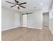 Spacious main bedroom featuring a ceiling fan, hardwood floors and a stylishly designed barn door at 623 15Th Nw Ave, Largo, FL 33770