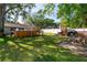 Spacious backyard featuring hot tub, brick BBQ, green lawn, and privacy fence at 6801 5Th N St, St Petersburg, FL 33702