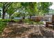 Large backyard with wooden deck, hot tub, green lawn, privacy fence, and mature trees at 6801 5Th N St, St Petersburg, FL 33702