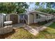 Rear view of house, walkway, and storage sheds, plus a view of the mature landscaping at 6801 5Th N St, St Petersburg, FL 33702