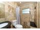 Bathroom features a tiled shower, a dark vanity, and neutral-toned tile walls at 6801 5Th N St, St Petersburg, FL 33702