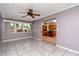 Dining room with tile floors and adjacent kitchen access, illuminated by a decorative ceiling fan fixture at 6801 5Th N St, St Petersburg, FL 33702