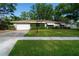 Charming single-story home featuring a well-manicured lawn, and a one car garage at 6801 5Th N St, St Petersburg, FL 33702