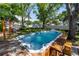 Relaxing backyard hot tub with wooden deck and lush greenery at 6801 5Th N St, St Petersburg, FL 33702