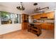 Charming kitchen featuring tile floors, wooden cabinets, island cart, and a window that provides natural light at 6801 5Th N St, St Petersburg, FL 33702