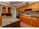 A well-lit kitchen with granite counters, tile backsplash, stainless appliances, and wooden cabinets at 6801 5Th N St, St Petersburg, FL 33702