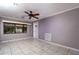 Well-lit living room with gray walls, ceiling fan, and tiled floor at 6801 5Th N St, St Petersburg, FL 33702