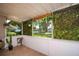 Relaxing outdoor patio featuring hanging plants and tile flooring, perfect for enjoying the neighborhood view at 6801 5Th N St, St Petersburg, FL 33702