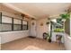 Enclosed porch featuring tile flooring, ceiling fan, windows, and plants at 6801 5Th N St, St Petersburg, FL 33702