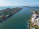 Stunning aerial view of coastline, showcasing the waterway, waterfront homes, and buildings near the beach at 690 Island Way # 707, Clearwater Beach, FL 33767