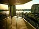 Scenic balcony view overlooking the water with a glimpse of the sunset and nearby buildings at 690 Island Way # 707, Clearwater Beach, FL 33767
