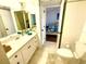 Bathroom with white vanity, toilet, and tile flooring, doorway open to adjacent bedroom at 690 Island Way # 707, Clearwater Beach, FL 33767