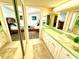 This bathroom has a single sink, mirrored wall, and access to a bedroom at 690 Island Way # 707, Clearwater Beach, FL 33767