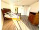 A bright bedroom has neutral walls, updated floors, and access to a hallway at 690 Island Way # 707, Clearwater Beach, FL 33767