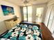 Bedroom has a double bed, balcony access and a dresser with a photo frame at 690 Island Way # 707, Clearwater Beach, FL 33767