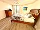 Spacious bedroom with balcony access and a tropical painting that brings the outdoors in at 690 Island Way # 707, Clearwater Beach, FL 33767