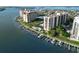 Scenic view of waterfront condominiums with boat docks, swimming pool, and well-maintained landscaping at 690 Island Way # 707, Clearwater Beach, FL 33767