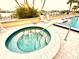 Close up view of a hot tub with tiled steps and a metal railing, adjacent to pool at 690 Island Way # 707, Clearwater Beach, FL 33767