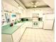 Bright kitchen with white cabinets, modern appliances, and an adjacent breakfast bar overlooking a water view at 690 Island Way # 707, Clearwater Beach, FL 33767