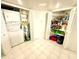 Well-organized laundry room and storage space with full-size washer/dryer and shelving units at 690 Island Way # 707, Clearwater Beach, FL 33767