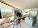 Bright living room with sliding glass doors to the balcony and an open layout to the dining area at 690 Island Way # 707, Clearwater Beach, FL 33767