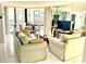 Living room with neutral sofas, mirrored wall, and glass table, with a dining area beyond at 690 Island Way # 707, Clearwater Beach, FL 33767