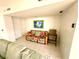 Cozy living room with vibrant floral sofa, accent chair, and bright tropical art piece at 690 Island Way # 707, Clearwater Beach, FL 33767