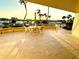 Beautiful sunset view from the waterfront patio with seating and lush tropical landscaping at 690 Island Way # 707, Clearwater Beach, FL 33767