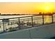 Waterfront view at sunset showcasing boat docks and city skyline, highlighting the coastal ambiance at 690 Island Way # 707, Clearwater Beach, FL 33767