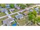 Birds-eye view of a home in a suburban neighborhood showcasing its well-manicured lawn and nearby amenities at 7041 Lexington Cir, Brooksville, FL 34602