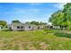 Beautifully maintained backyard showcasing mature trees, a well-kept lawn, and serene outdoor living space at 7041 Lexington Cir, Brooksville, FL 34602