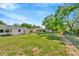 Spacious backyard showcasing a well-maintained lawn, mature trees, and plenty of room for outdoor activities at 7041 Lexington Cir, Brooksville, FL 34602