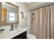 Bathroom featuring shower and tub combination with dark wooden cabinets and a mirror at 7041 Lexington Cir, Brooksville, FL 34602